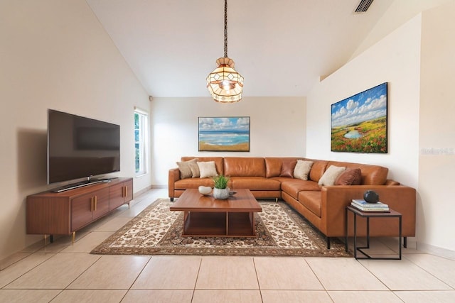 1515 Lions Club Dr, Brandon, FL 33511 - living area with lofted ceiling, light tile patterned floors, and baseboards