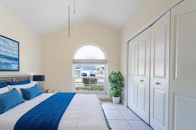 1515 Lions Club Dr, Brandon, FL 33511 - bedroom with light tile patterned flooring, lofted ceiling, and a closet