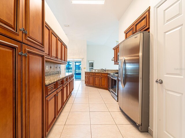1515 Lions Club Dr, Brandon, FL 33511 - kitchen with appliances with stainless steel finishes, light tile patterned floors, light stone counters, lofted ceiling, and decorative backsplash