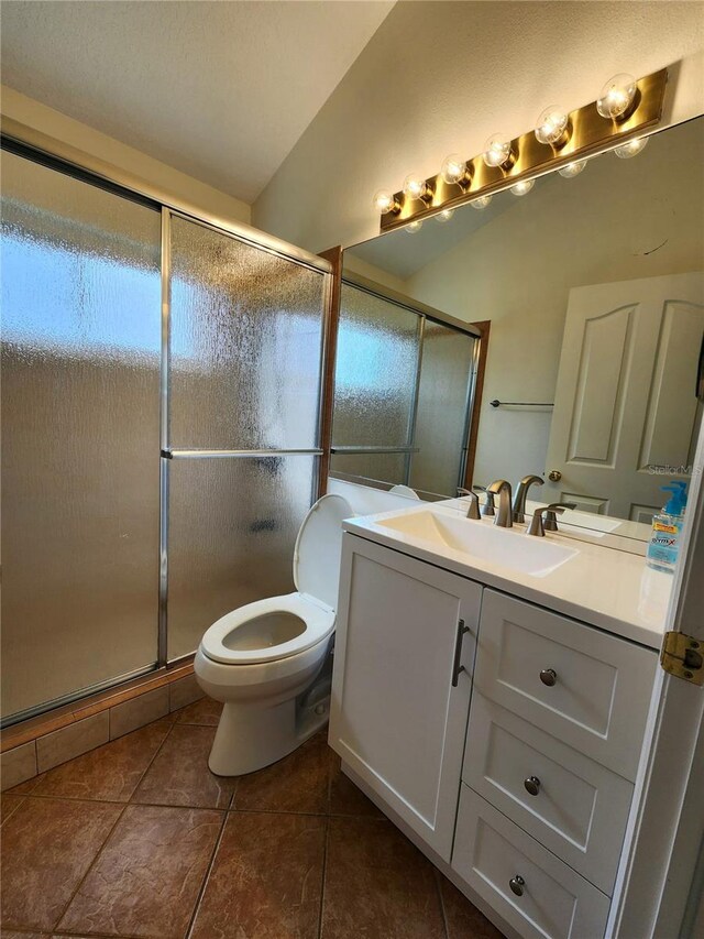 1515 Lions Club Dr, Brandon, FL 33511 - full bathroom with vanity, toilet, tile patterned flooring, and a shower with door