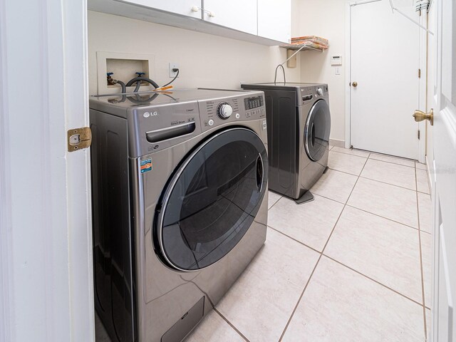 1515 Lions Club Dr, Brandon, FL 33511 - laundry room featuring cabinet space, independent washer and dryer, and light tile patterned floors