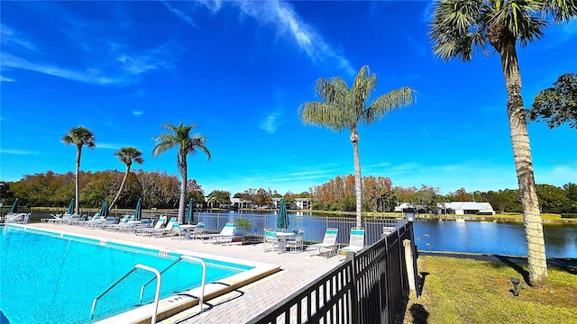 view of pool with a patio area and a water view