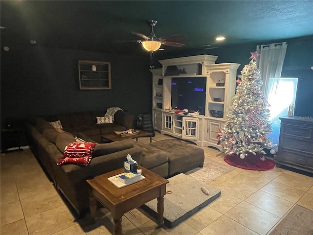 living room featuring light tile patterned floors and ceiling fan