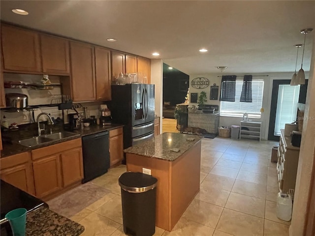 kitchen featuring a center island, sink, decorative light fixtures, stainless steel fridge with ice dispenser, and black dishwasher