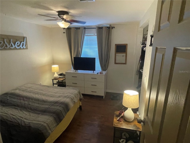 bedroom with ceiling fan and dark wood-type flooring