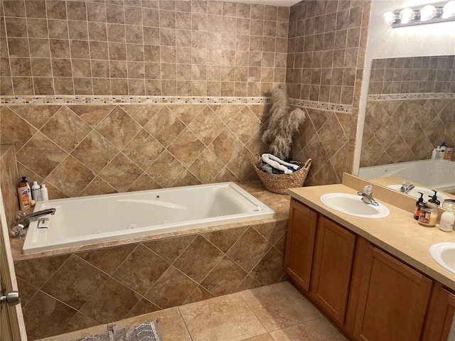 bathroom featuring tiled bath, tile patterned flooring, vanity, and tile walls