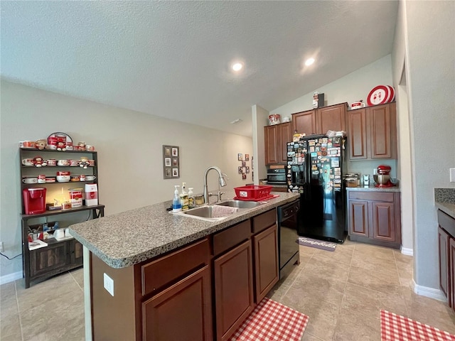 kitchen with a textured ceiling, vaulted ceiling, a kitchen island with sink, sink, and black appliances