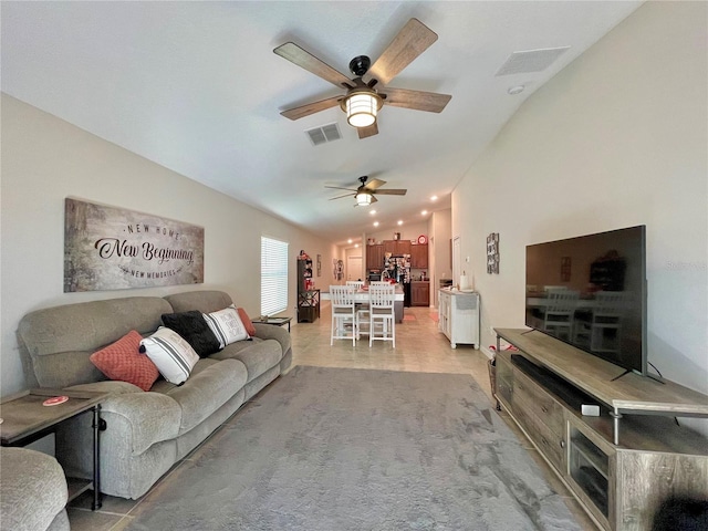 living room with ceiling fan and vaulted ceiling