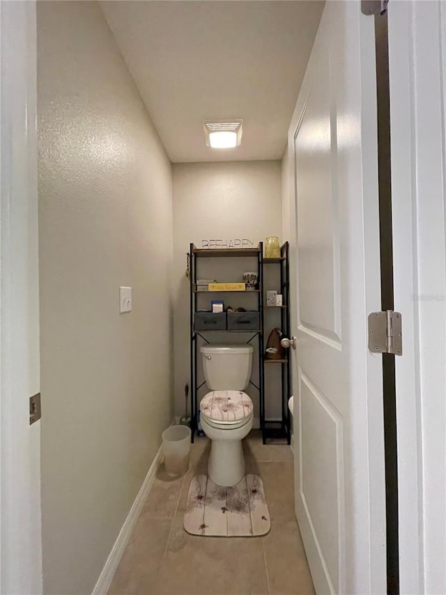 bathroom featuring tile patterned flooring and toilet