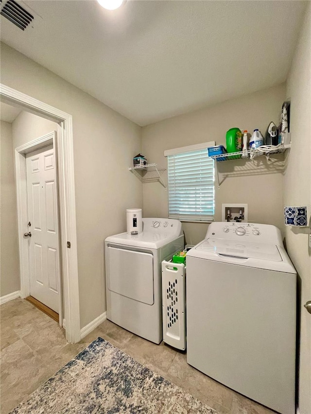 laundry area with independent washer and dryer