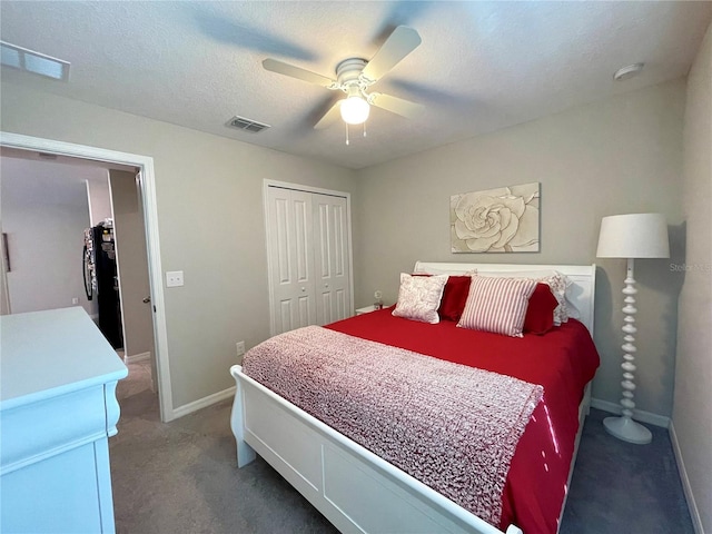 bedroom with carpet flooring, black refrigerator, a textured ceiling, ceiling fan, and a closet