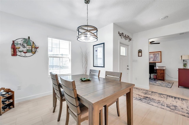 dining room with ceiling fan and a textured ceiling