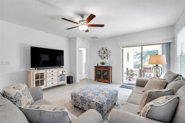 living room with ceiling fan and light wood-type flooring