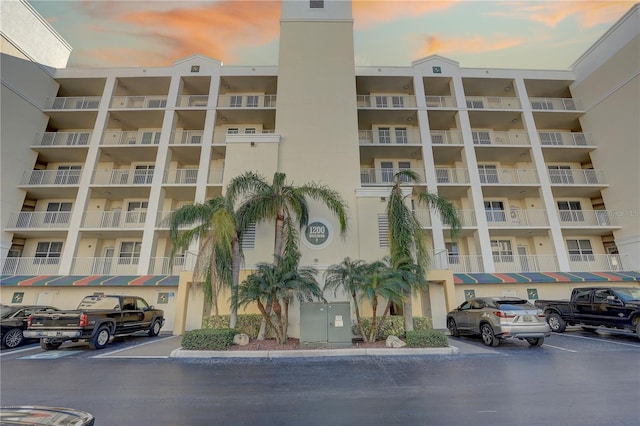 1200 Country Club Dr Unit 2504, Largo, FL 33771 - property at dusk featuring a view of apartment building / complex and uncovered parking