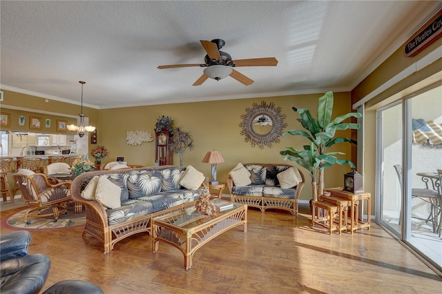 1200 Country Club Dr Unit 2504, Largo, FL 33771 - living area featuring wood finished floors, ceiling fan, crown molding, a chandelier, and a textured ceiling