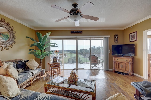 1200 Country Club Dr Unit 2504, Largo, FL 33771 - living room with plenty of natural light, a textured ceiling, a ceiling fan, hardwood / wood-style floors, and crown molding