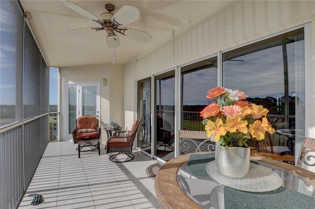 sunroom / solarium featuring ceiling fan