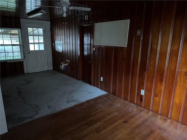 interior space with wood walls and wood-type flooring