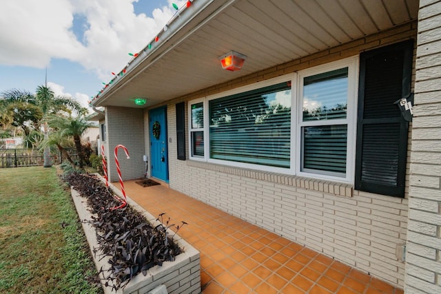 view of exterior entry with a yard