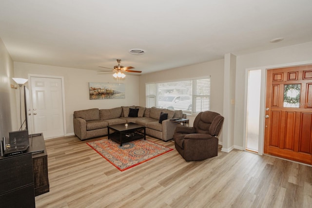 living room featuring light wood-type flooring and ceiling fan