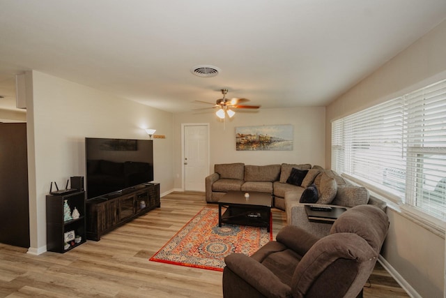 living room with ceiling fan and light hardwood / wood-style flooring