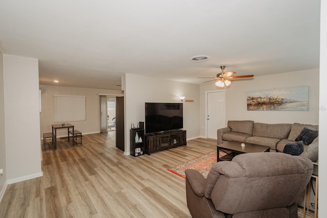 living room featuring ceiling fan and light wood-type flooring