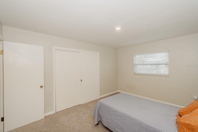 carpeted bedroom featuring a closet