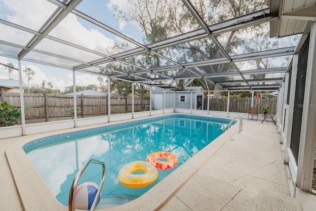 view of pool featuring a shed and a lanai