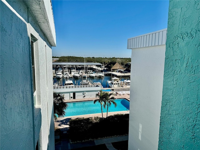 view of swimming pool featuring a water view