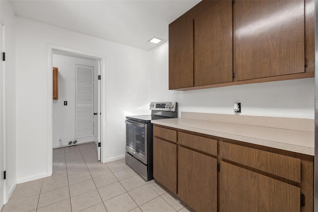 kitchen with electric range and light tile patterned floors