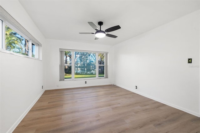 spare room with ceiling fan and light hardwood / wood-style floors