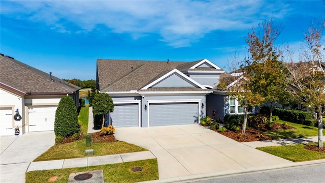 7506 Parkshore Dr, Apollo Beach, FL 33572 - view of front of home with stucco siding, concrete driveway, a garage, and roof with shingles