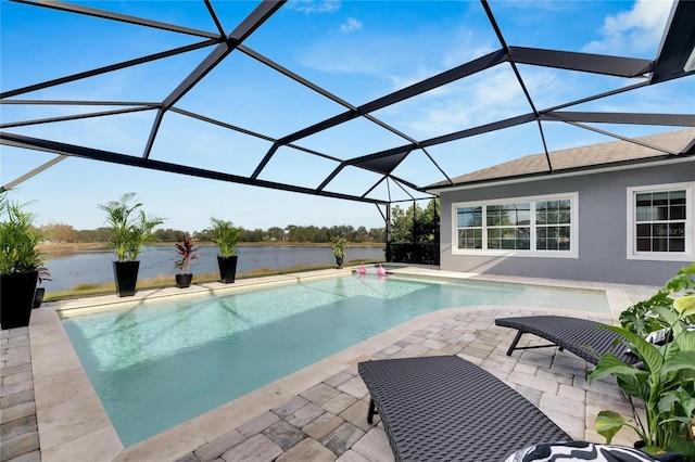 view of pool with a patio, a water view, and glass enclosure