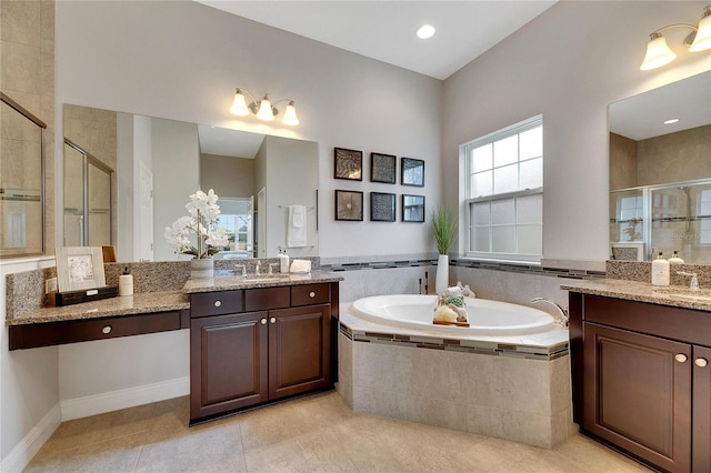 7506 Parkshore Dr, Apollo Beach, FL 33572 - bathroom featuring a stall shower, a garden tub, two vanities, and tile patterned flooring