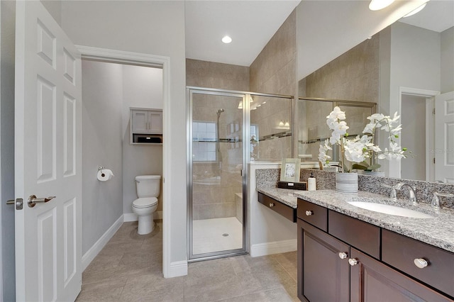 bathroom featuring tile patterned flooring, vanity, toilet, and an enclosed shower