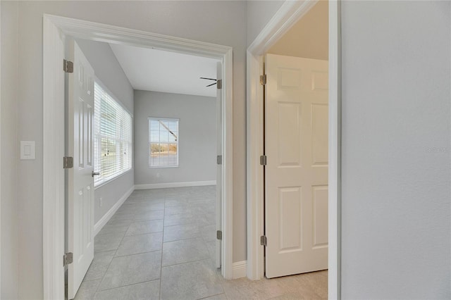 hall featuring light tile patterned flooring