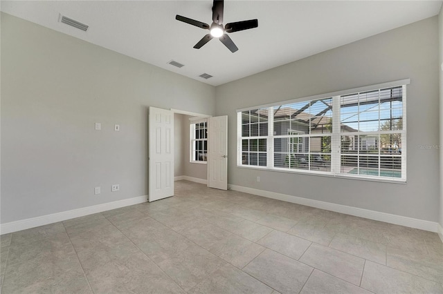 7506 Parkshore Dr, Apollo Beach, FL 33572 - tiled empty room featuring a ceiling fan and baseboards
