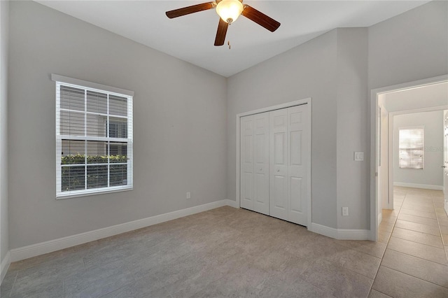 unfurnished bedroom featuring a closet, ceiling fan, and light tile patterned flooring