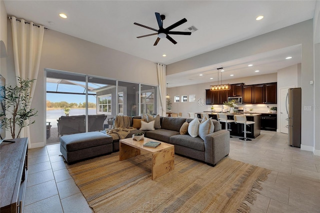 living room with light tile patterned floors and ceiling fan