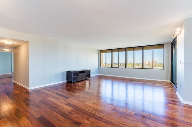 unfurnished living room with dark wood-type flooring