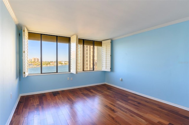 unfurnished room with crown molding and dark hardwood / wood-style flooring