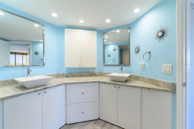 bathroom with hardwood / wood-style floors and vanity