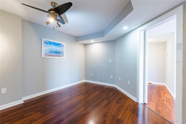 spare room with ceiling fan and dark wood-type flooring