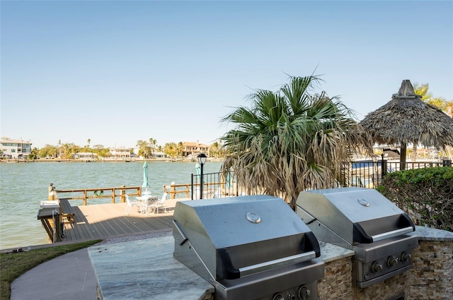 view of patio / terrace featuring a grill and a deck with water view