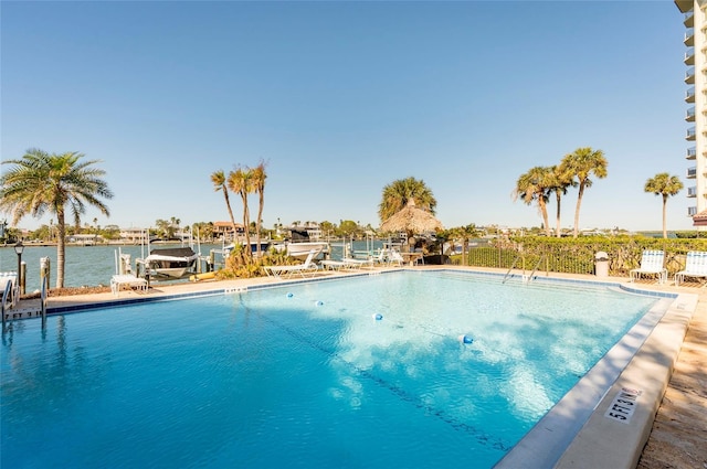 view of pool with a boat dock and a water view