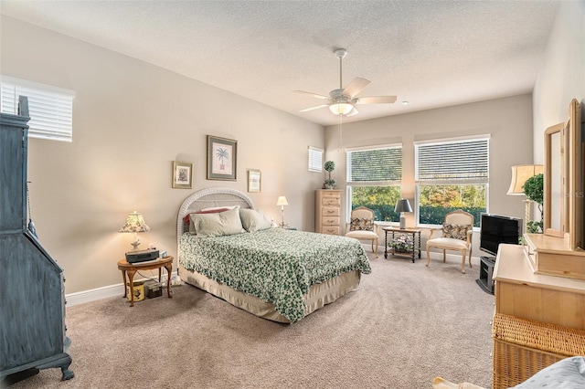 bedroom featuring carpet, ceiling fan, and a textured ceiling