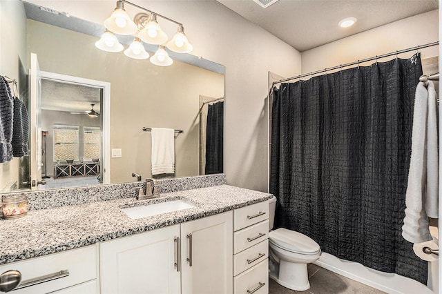 full bathroom with ceiling fan, tile patterned flooring, toilet, vanity, and shower / tub combo