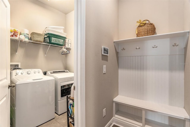 laundry room with light tile patterned flooring and separate washer and dryer