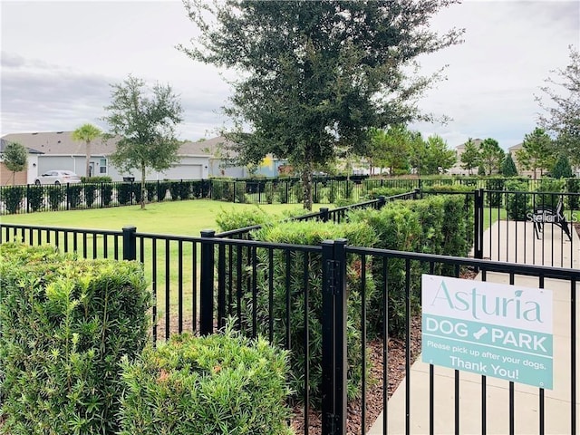 view of gate with a yard