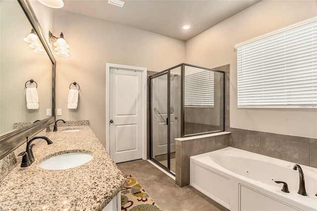 full bathroom featuring double vanity, a jetted tub, a sink, and a shower stall